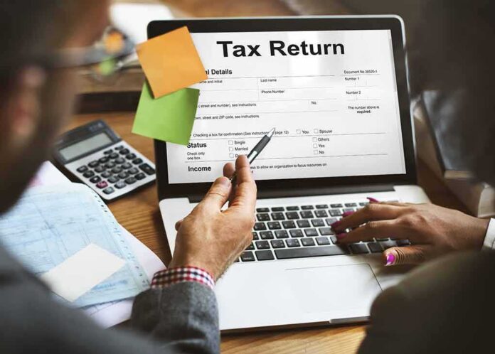 shutterstock_495808516-5 Laptop displaying tax return form
