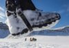 Snow-covered boot steps across a snowy landscape
