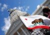 California state flag in front of a white domed capitol building