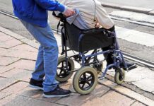 Autistic Man Dies After Staff Clash Caregiver pushing person in wheelchair over curb