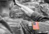 Soldier saluting with an American flag patch on sleeve
