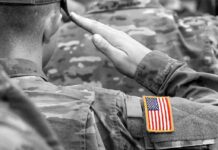 Firing Squad Online – Who Hit Go? Soldier saluting with an American flag patch on sleeve