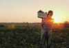 Weed Whacker vs. Knife – Guess Who Ran Farmer carrying a crate of vegetables at sunset in a field