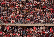 Viral Drink Toss ENDS State Dept Career Peter Keys in a large stadium crowd of football fans