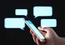 Campaign Text Tsunami Backfires Hand holding smartphone with chat bubbles on dark background
