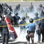 David Givens among police and protesters in a smoky street confrontation