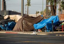 LA Fires: Promises Without Placements Street tents covered with tarps along a sidewalk