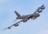 Military bomber aircraft banking in flight