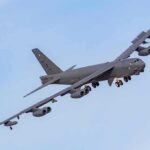 Military bomber aircraft banking in flight