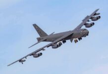 Military bomber aircraft banking in flight