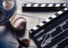 Cocaine Budgeted On Caddyshack? Film reel and clapperboard on wooden surface