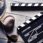 Cocaine Budgeted On Caddyshack? Film reel and clapperboard on wooden surface