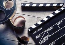 Cocaine Budgeted On Caddyshack? Film reel and clapperboard on wooden surface