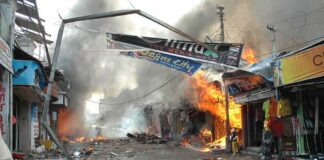 Street marketplace engulfed in fire and heavy smoke