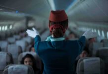 Hijack Code Triggers Fighter Scramble Flight attendant giving safety demonstration in airplane aisle