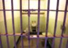Governor Showdown Looms Over Manson Follower Interior of a prison cell with a toilet, sink, and metal bars