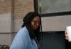 Whoopi Goldberg outdoors in a denim jacket looking at the camera