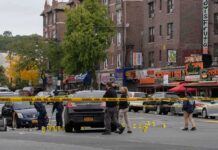 DOJ Bombshell Ties U.S. Plot To Massacre Police investigate a taped-off urban street crime scene