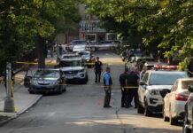 Shots Fired, Judge Lets Him Out Police officers secure a residential street with patrol cars and yellow tape