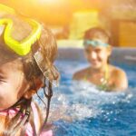 children playing in a swimming pool with goggles
