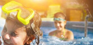 children playing in a swimming pool with goggles