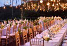 Pre-Wedding, Big Optics, Bigger Questions Elegant outdoor reception tables under hanging lights