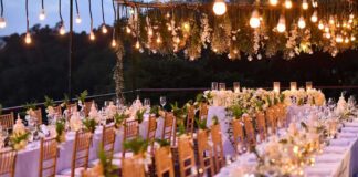 Elegant outdoor reception tables under hanging lights