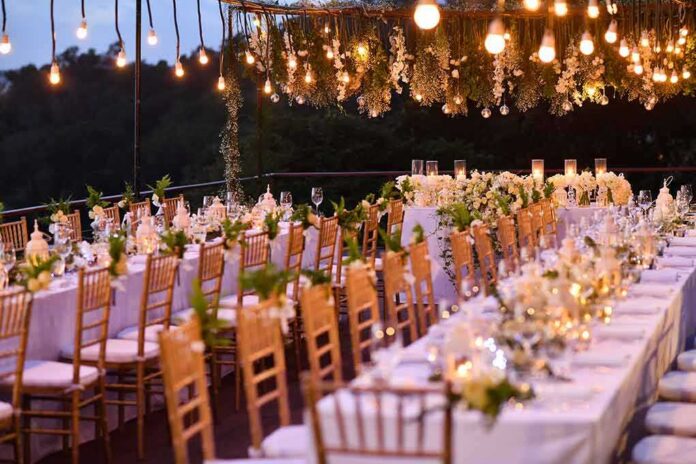 shutterstock_512157103-1 Elegant outdoor reception tables under hanging lights