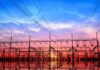 Electrical substation with power lines at sunset