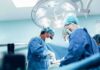 Spinal Cord Graft Claims Face a Reality Check surgeons performing an operation under bright surgical lights