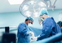 surgeons performing an operation under bright surgical lights