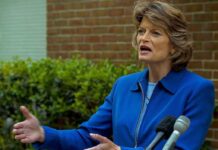 Alaska Earthquake: Senator Backs Dem Governor Bid Lisa Murkowski speaking at an outdoor press conference with microphones in front